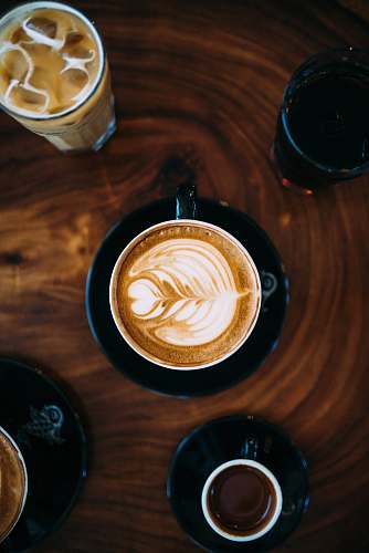 coffee cup cup coffee with milk frothed on brown tabletop cup